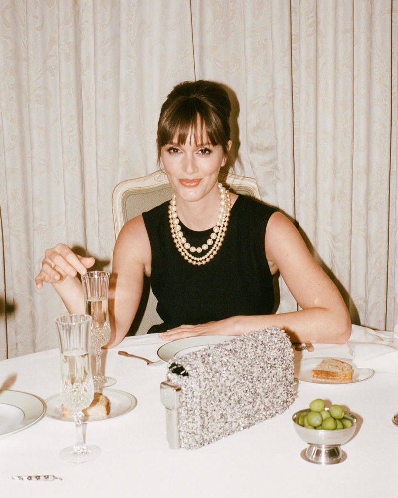 Posing at a dinner table, Leighton Meester wears ladylike pearls in the St. John x Edie Parker campaign.