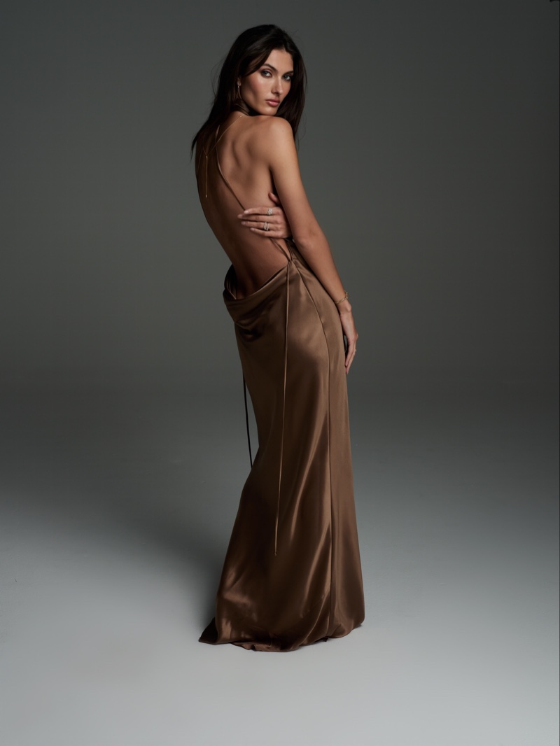 A backless bronze maxi dress from Logan Hollowell's silk collection makes a statement.