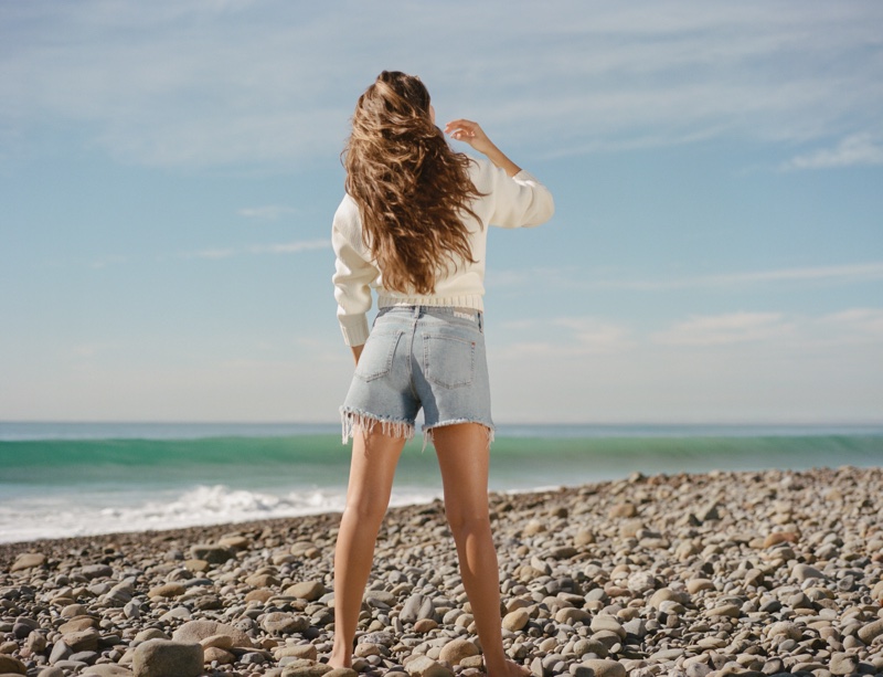 Rachel Connor shows off cut-off denim shorts for the Mavi spring 2024 campaign.