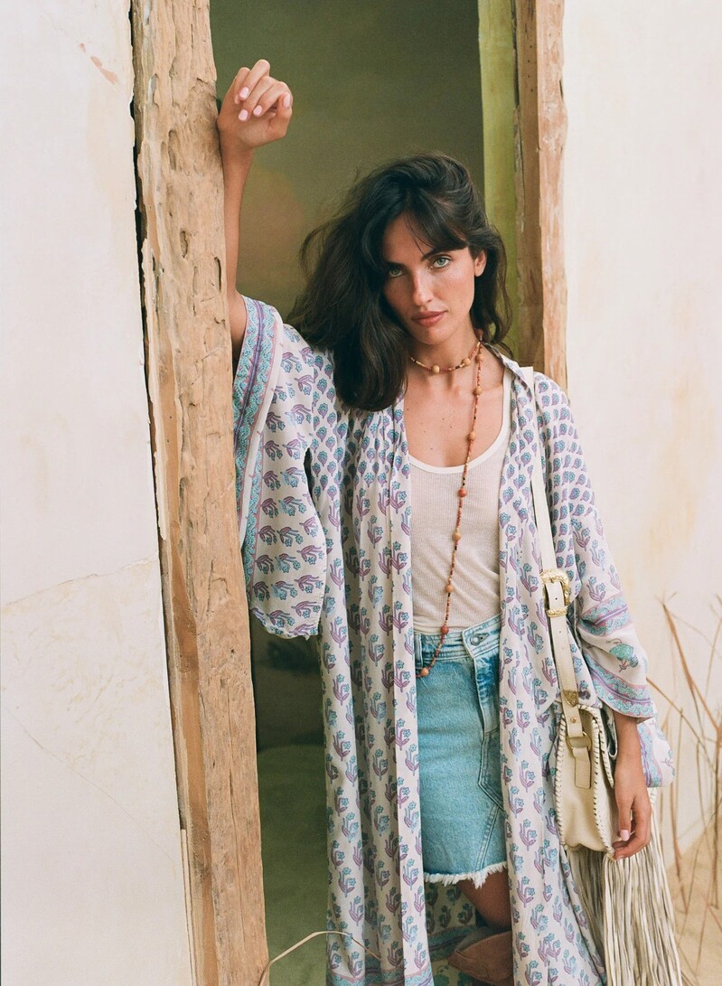 Laura Bensadoun poses in a laid-back kimono and denim skirt for Spell's Bohemian Royale Renew line.