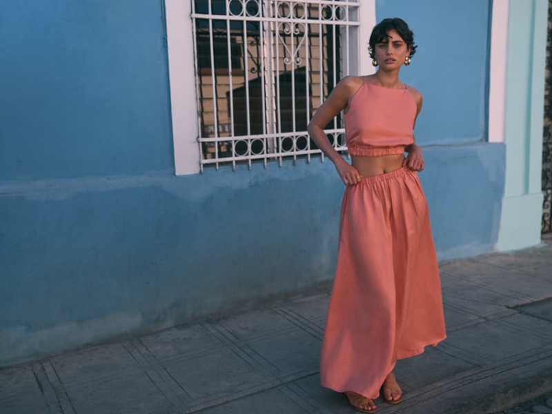 Looking pretty in coral, Taylor Hill poses in crop top and skirt set from Banana Republic's summer 2024 collection.