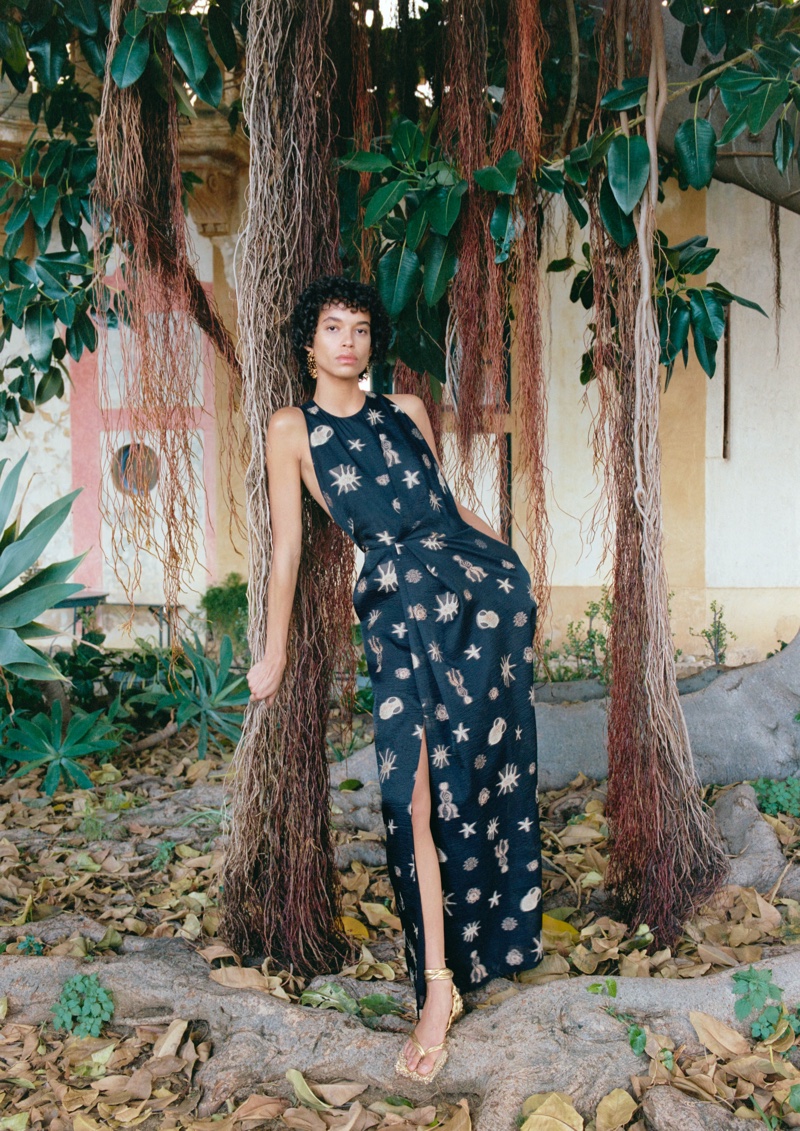 Capturing the spirit of H&M Studio's resort 2024 collection, the model wears a bold black dress, accentuated with embellished details.