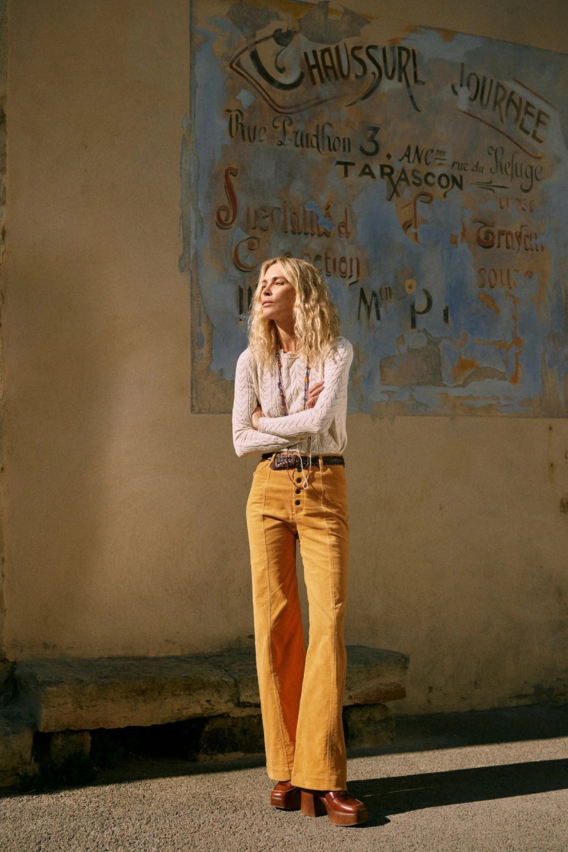 Erin Wasson stands confidently in mustard pants and a knit blouse in the South of France for Spell.
