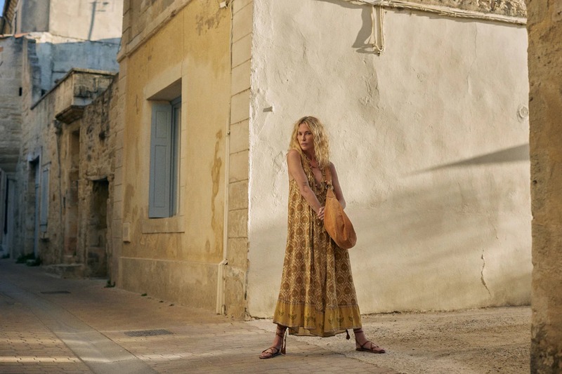 Erin Wasson wanders an alley in a flowing, patterned maxi dress for Spell.