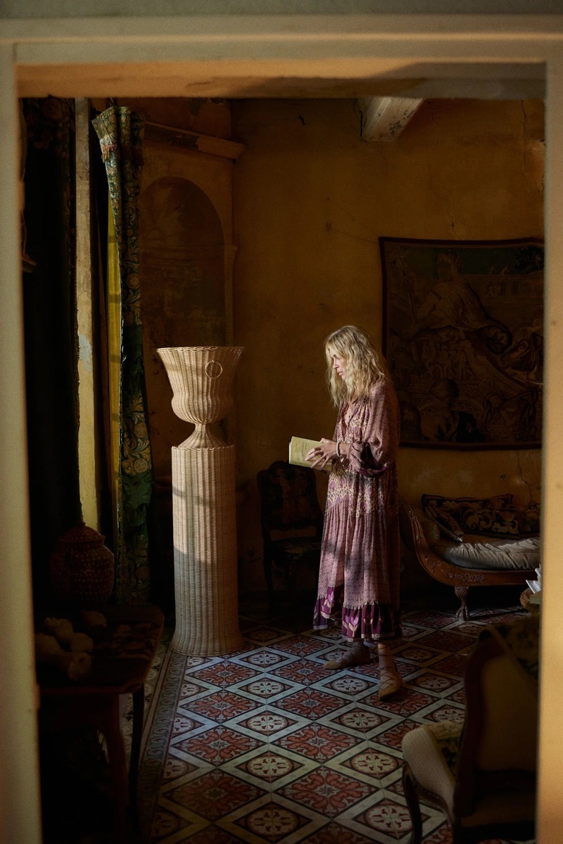 Erin Wasson reads intently in a vintage-patterned dress for the Spell Bohème campaign.