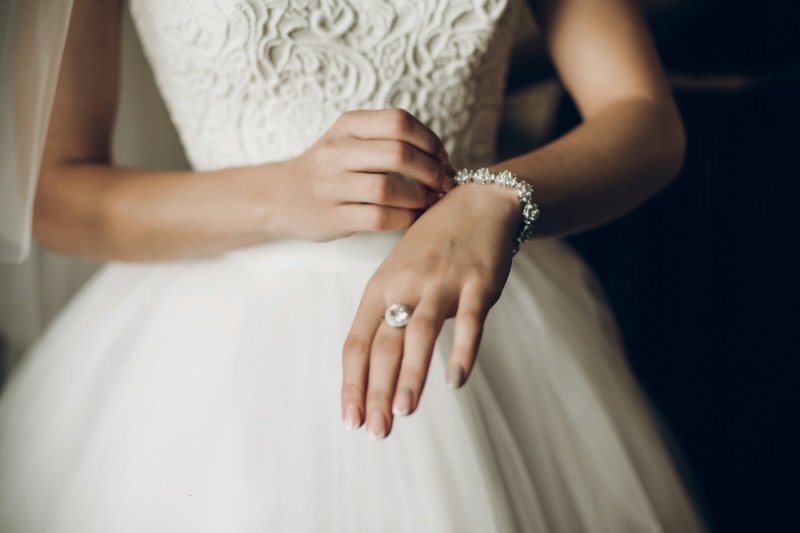 Bride Putting on Jewelry
